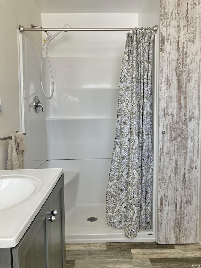 bathroom with vanity, hardwood / wood-style flooring, and curtained shower