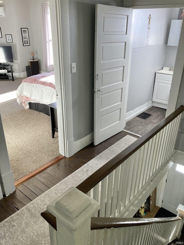 staircase with hardwood / wood-style flooring