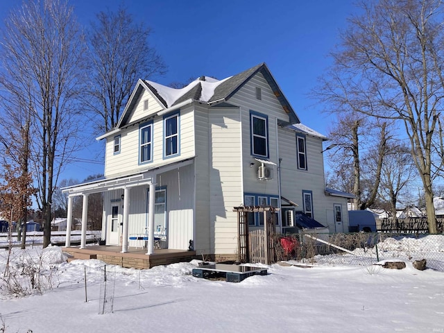 view of front facade with a porch and fence