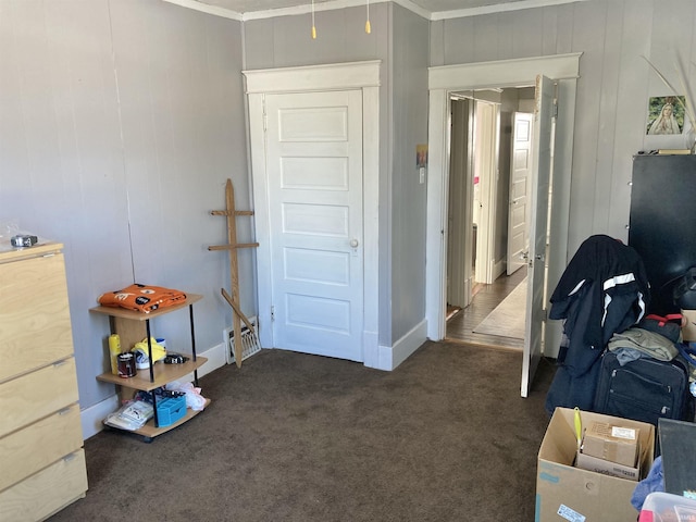 bedroom featuring dark carpet and ornamental molding