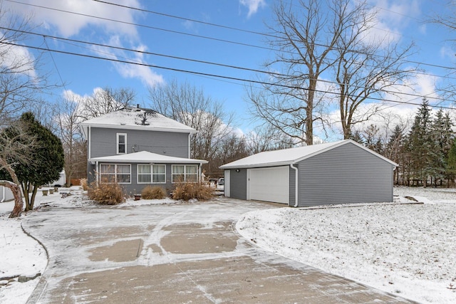 exterior space with a garage and an outbuilding