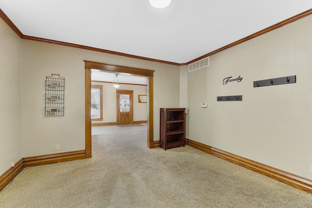 carpeted spare room featuring ornamental molding