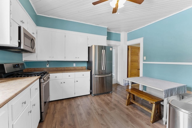 kitchen with ceiling fan, light hardwood / wood-style floors, white cabinetry, and stainless steel appliances