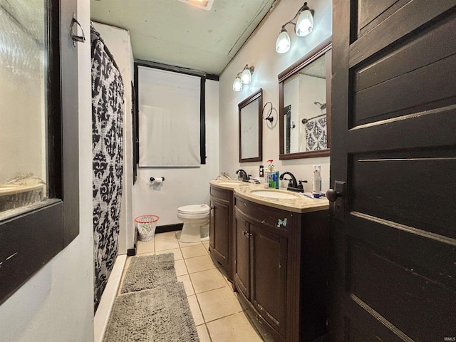 bathroom featuring tile patterned floors, vanity, and toilet