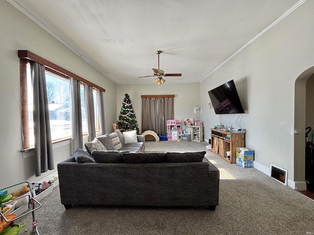 living room featuring carpet flooring, ceiling fan, and ornamental molding