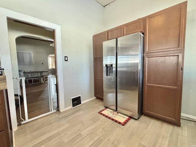 kitchen featuring light hardwood / wood-style flooring and stainless steel refrigerator with ice dispenser