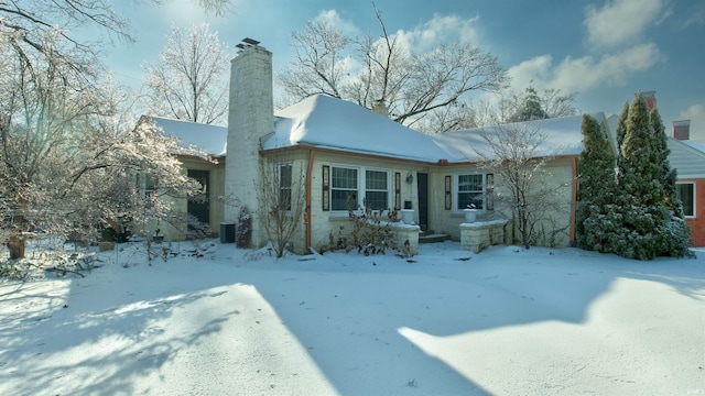 view of snow covered rear of property