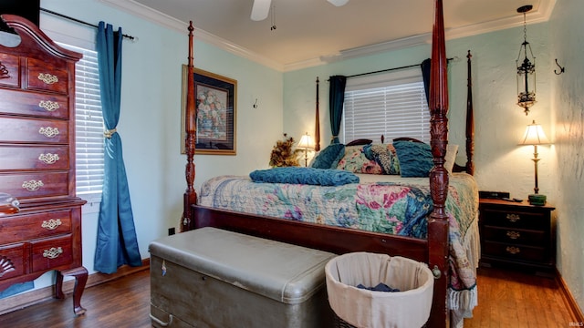 bedroom with hardwood / wood-style flooring, ceiling fan, and crown molding