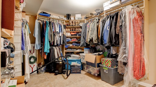 walk in closet featuring light tile patterned flooring