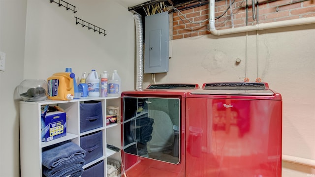 laundry room featuring electric panel and washer and clothes dryer