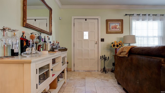 entrance foyer with crown molding and bar area