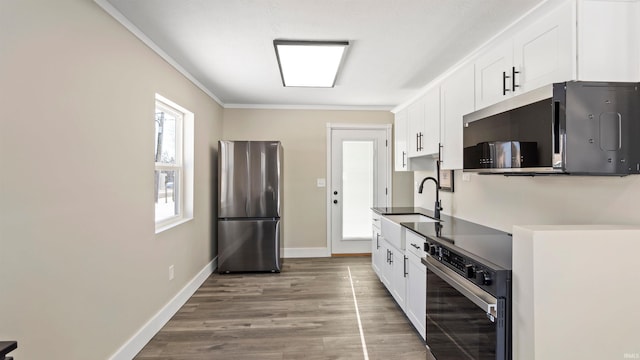 kitchen with crown molding, sink, white cabinets, and stainless steel appliances