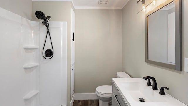 bathroom featuring hardwood / wood-style flooring, toilet, vanity, and walk in shower