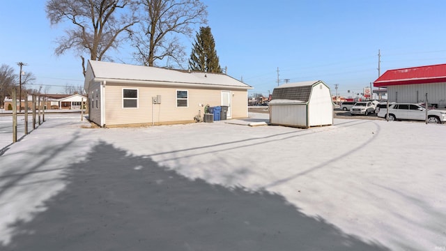 rear view of house with a storage unit