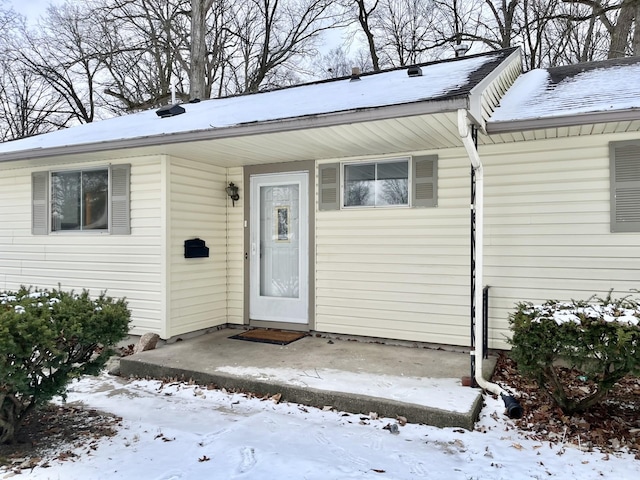 view of snow covered property entrance