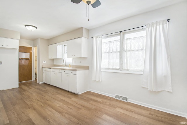 kitchen featuring white cabinetry, sink, ceiling fan, and light hardwood / wood-style flooring