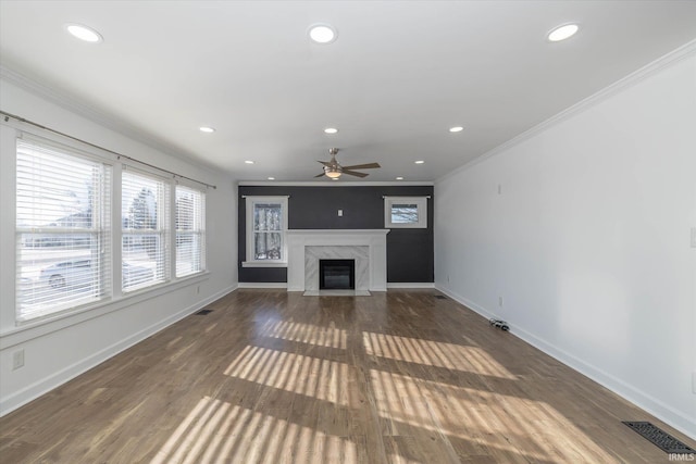 unfurnished living room with ceiling fan, a fireplace, dark hardwood / wood-style floors, and ornamental molding