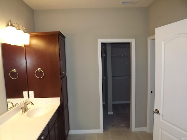 bathroom with tile patterned flooring and vanity