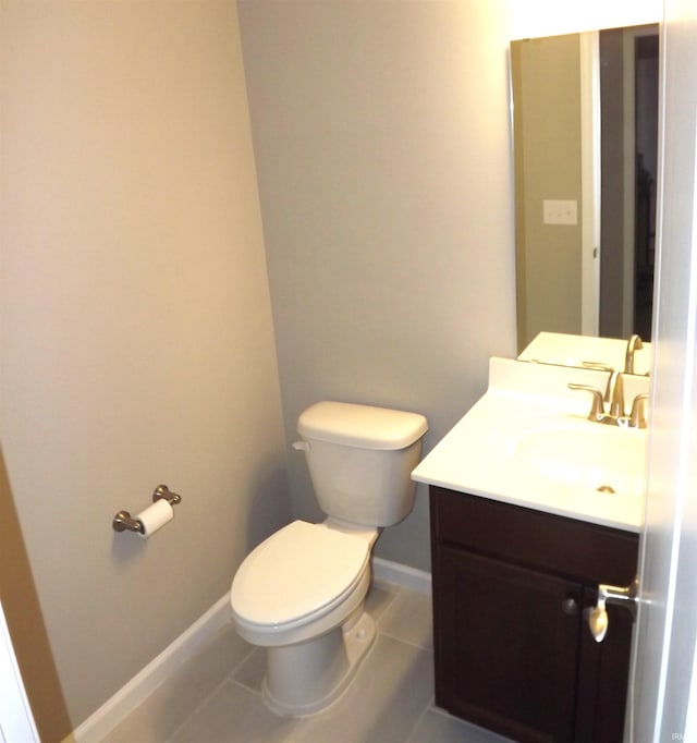 bathroom featuring tile patterned flooring, vanity, and toilet