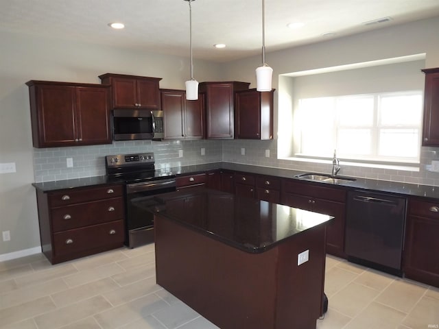 kitchen with a center island, hanging light fixtures, sink, appliances with stainless steel finishes, and tasteful backsplash