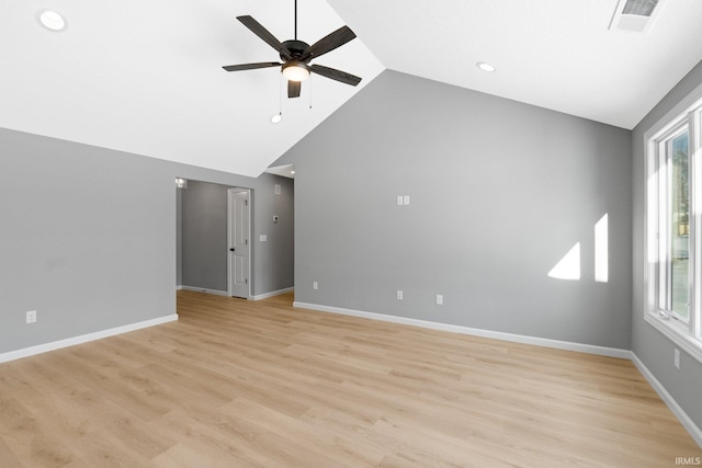 unfurnished living room featuring plenty of natural light, ceiling fan, light wood-type flooring, and high vaulted ceiling