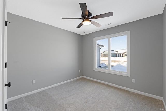 empty room with ceiling fan and light colored carpet