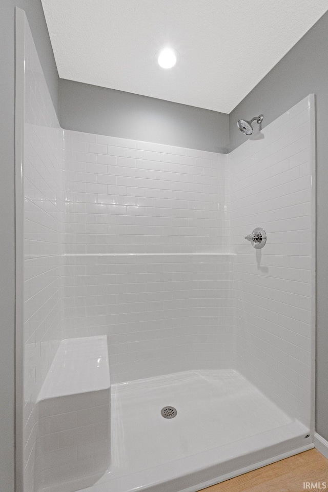 bathroom featuring a shower and hardwood / wood-style floors