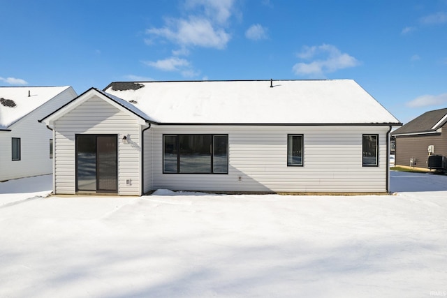 snow covered back of property with central air condition unit