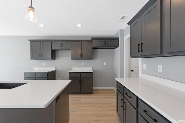 kitchen with hanging light fixtures and light hardwood / wood-style floors