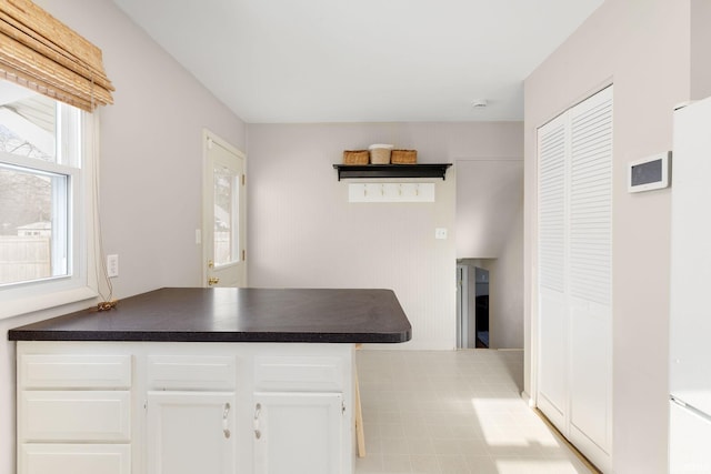 kitchen with kitchen peninsula and white cabinetry