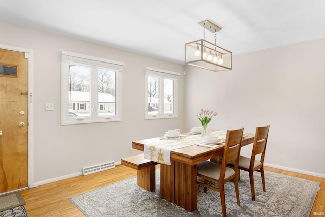 dining space with wood-type flooring