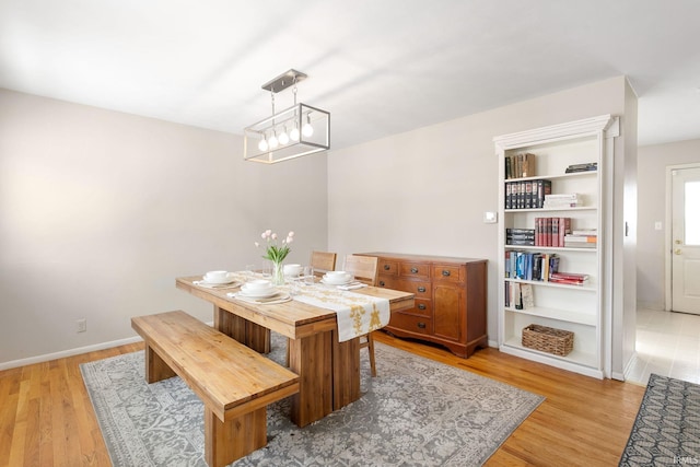 dining space with a chandelier and light wood-type flooring