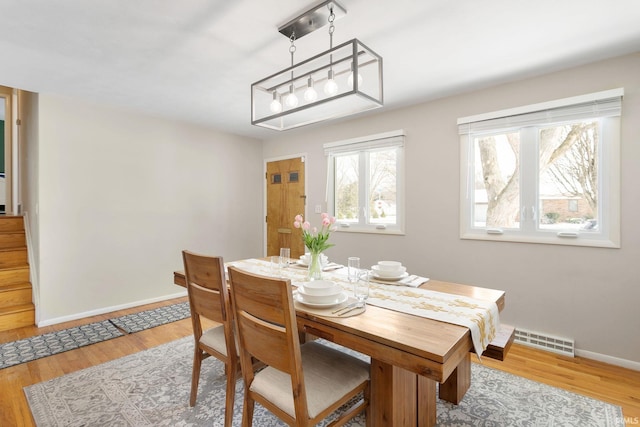 dining area with light hardwood / wood-style floors