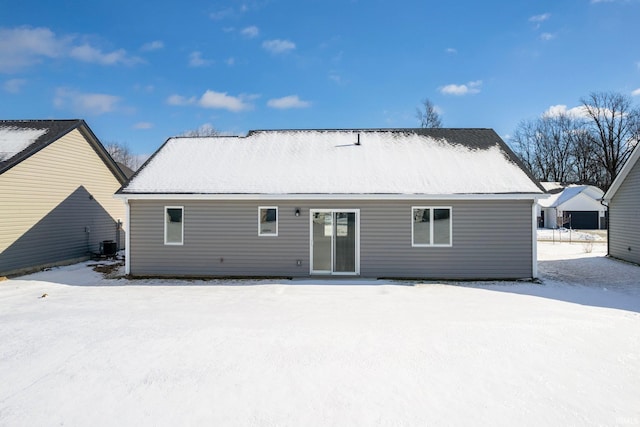 snow covered property featuring central air condition unit