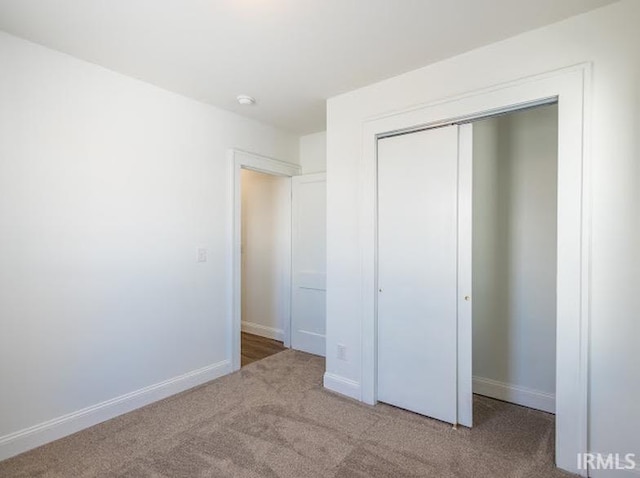 unfurnished bedroom featuring a closet and carpet floors