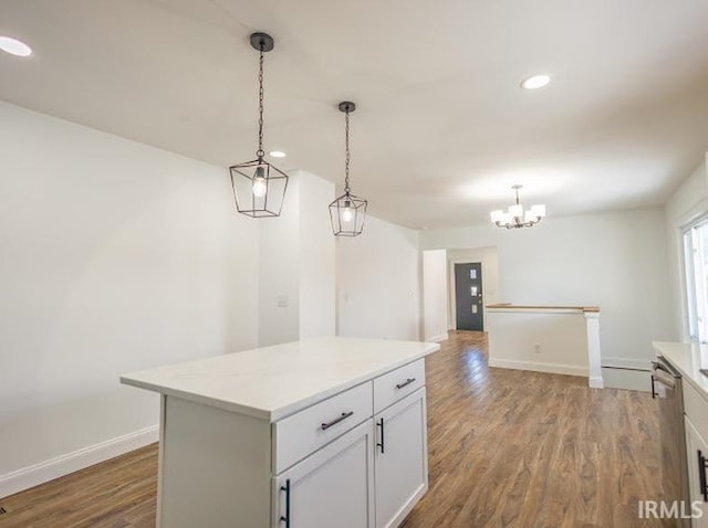 kitchen with pendant lighting, a center island, white cabinets, and hardwood / wood-style floors