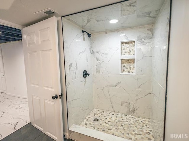 bathroom with a tile shower