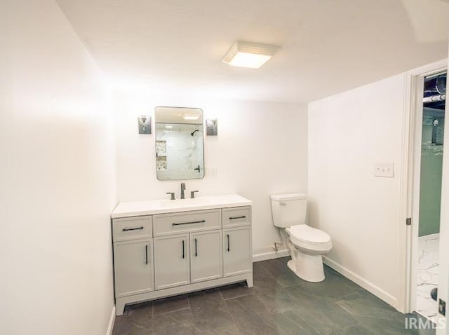 bathroom with a shower, vanity, and toilet