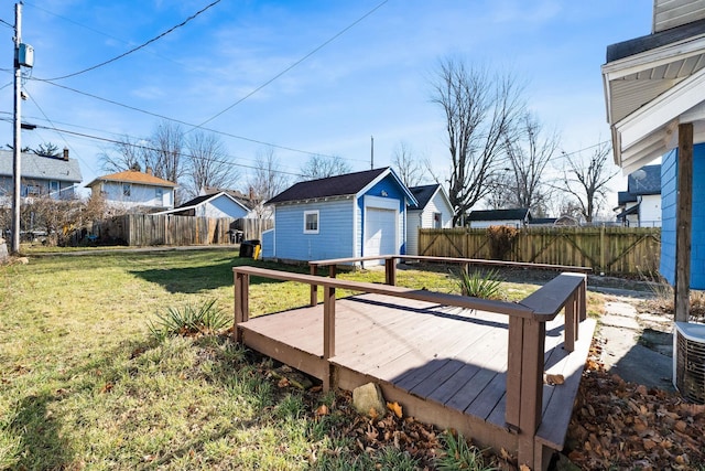 wooden terrace featuring a lawn, cooling unit, and a storage shed