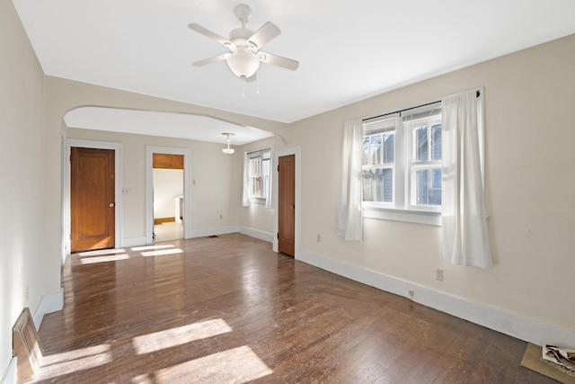 spare room with ceiling fan and dark wood-type flooring