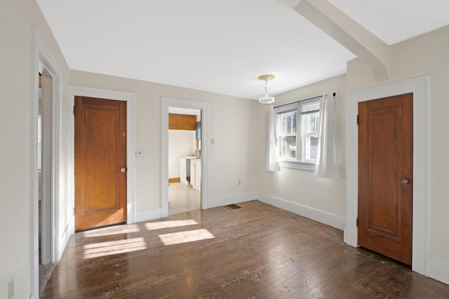 unfurnished bedroom featuring dark hardwood / wood-style floors