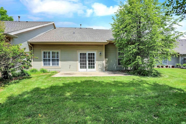 back of house with a yard and a patio