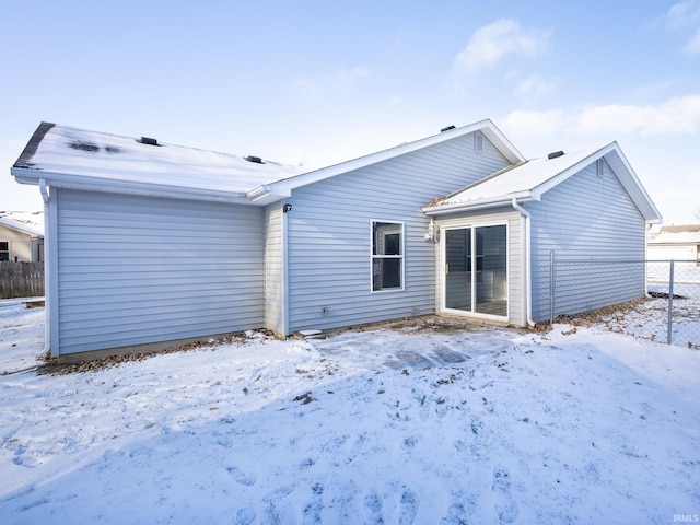 view of snow covered rear of property