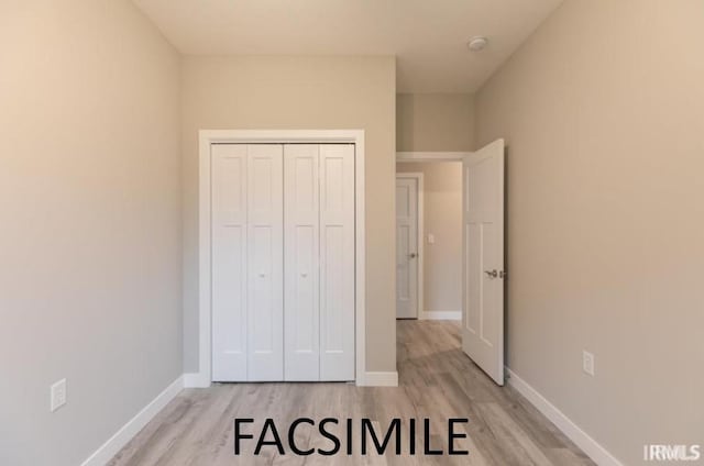 bedroom featuring a closet and light hardwood / wood-style flooring