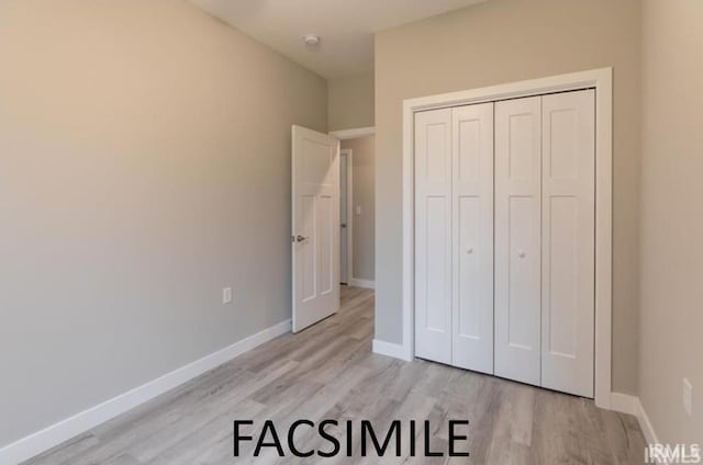 unfurnished bedroom featuring light hardwood / wood-style flooring and a closet