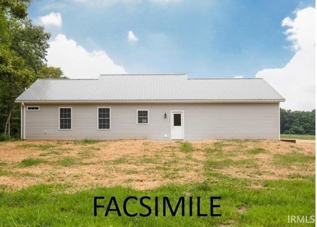 rear view of house featuring a yard