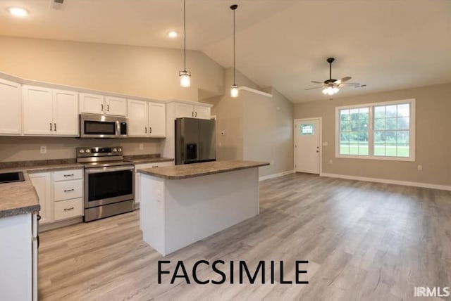 kitchen with white cabinets, ceiling fan, decorative light fixtures, a kitchen island, and stainless steel appliances