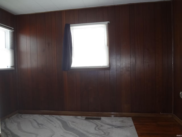 empty room featuring wood walls