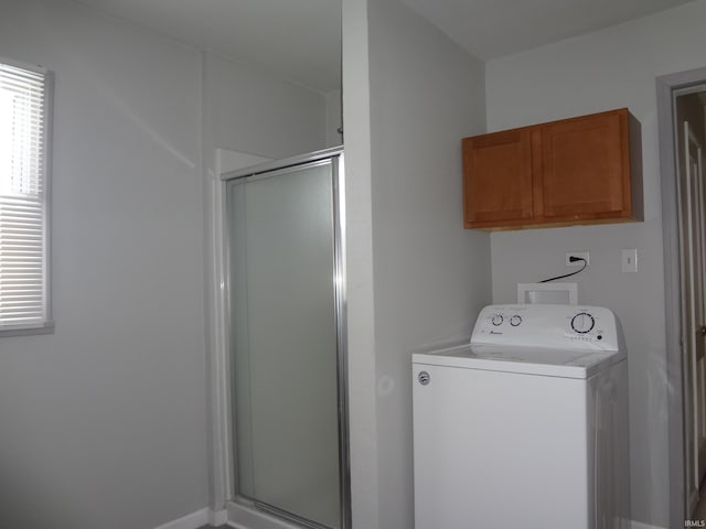 washroom featuring cabinets and washer / dryer