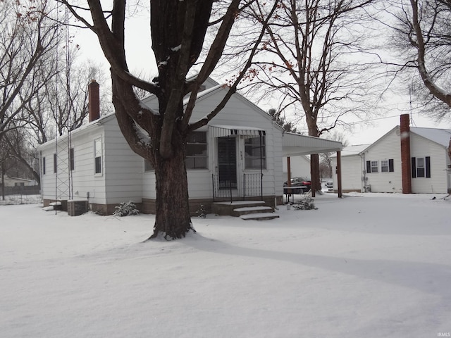 snow covered property featuring central AC